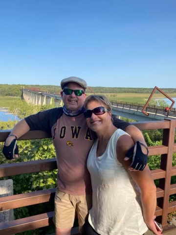 Couple pausing for a photo opp while on a bike ride with bikes rented from Dubuque E-Bikes